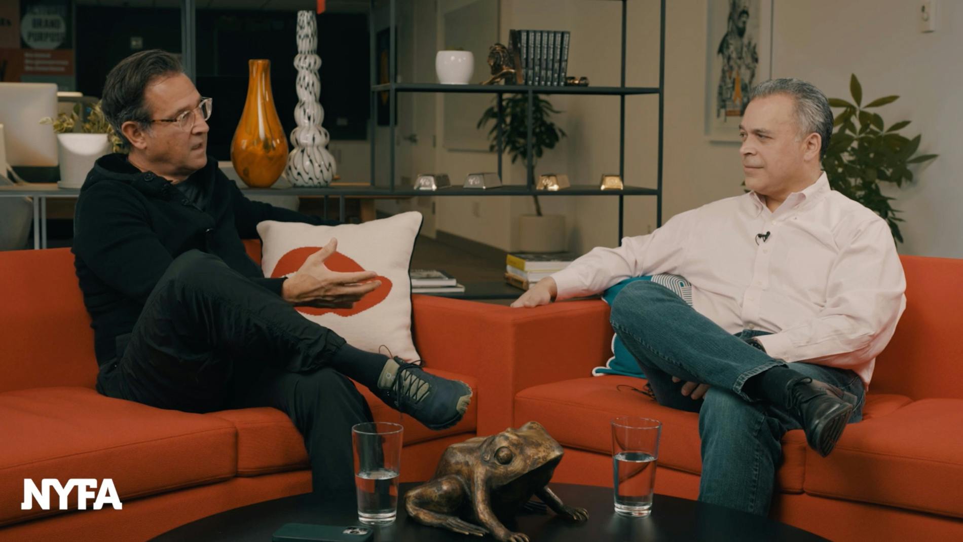 Image of Scott Goodson interviewing Ramon Soto on an orange sofa