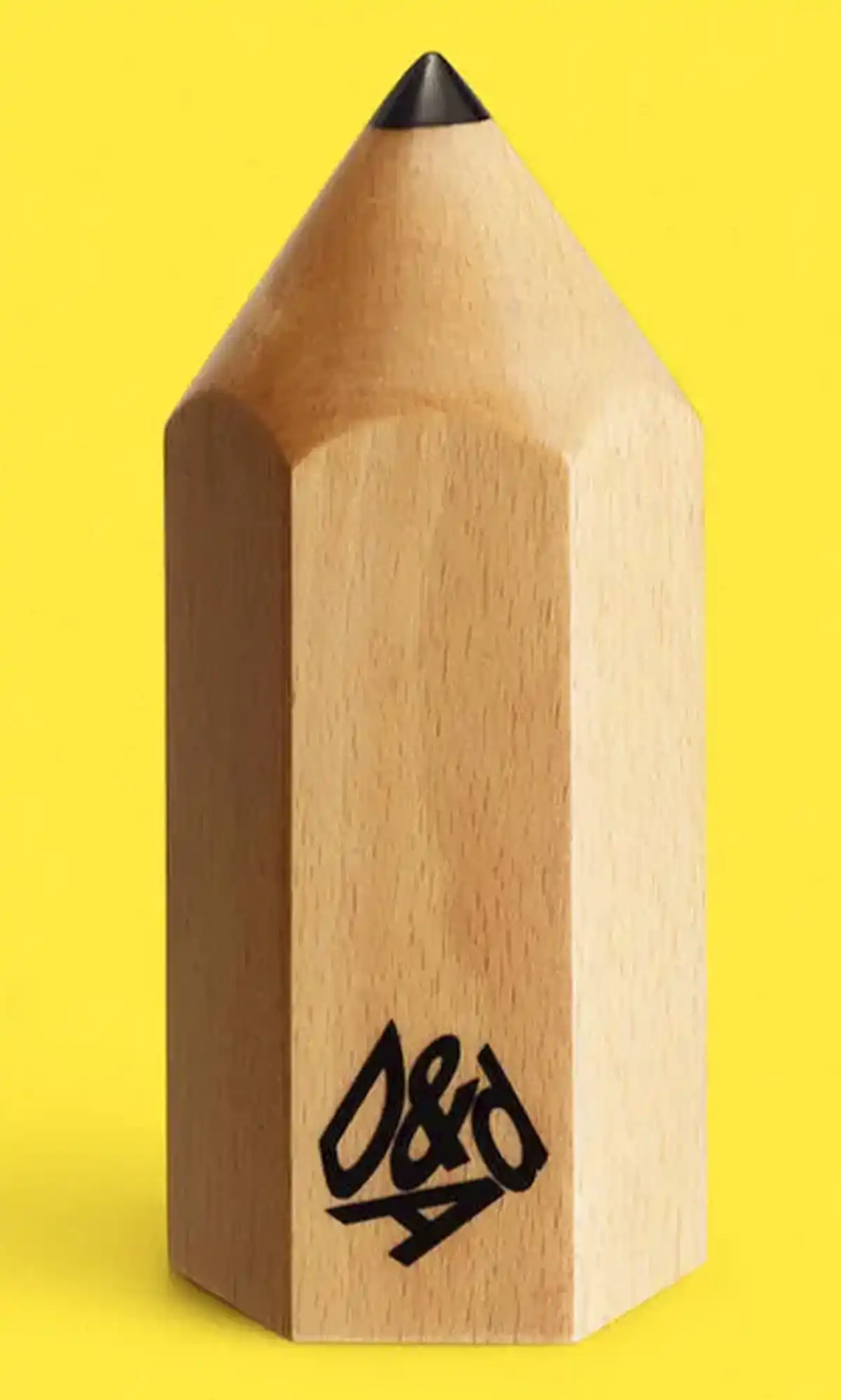 D&AD wooden pencil award trophy on yellow background - symbol of creative excellence in design and advertising