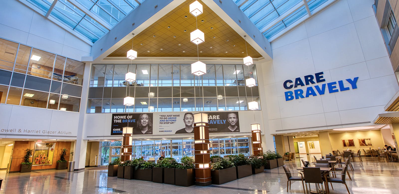 Visuals from the “Care Bravely” campaign are displayed in an indoor lobby.