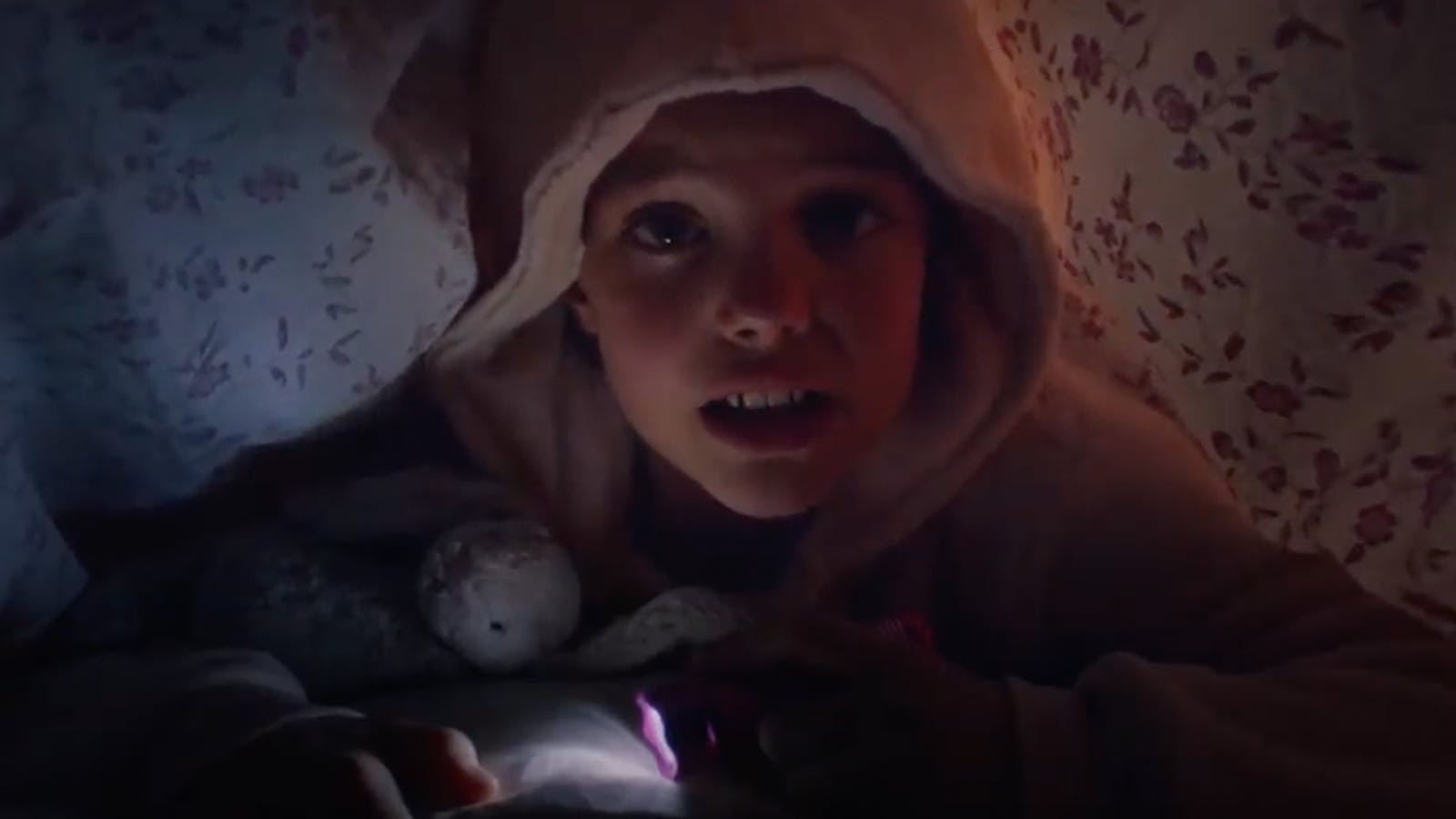 A young scared child holds onto his plushie underneath the covers for the “Monsters” LifeBridge campaign.