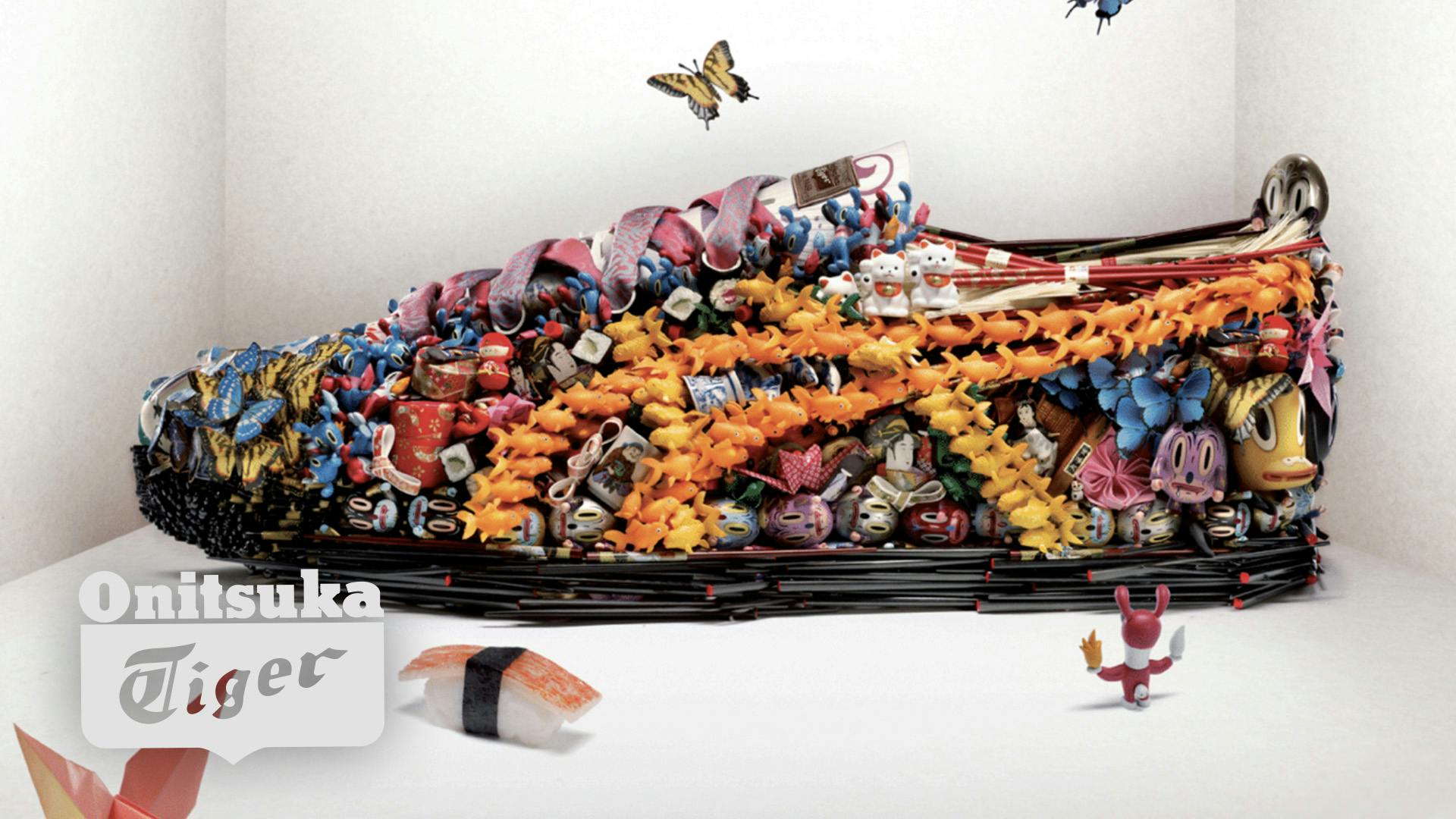 A detailed shot of a sneaker made of small figurines, including fish, butterflies, and cats. 